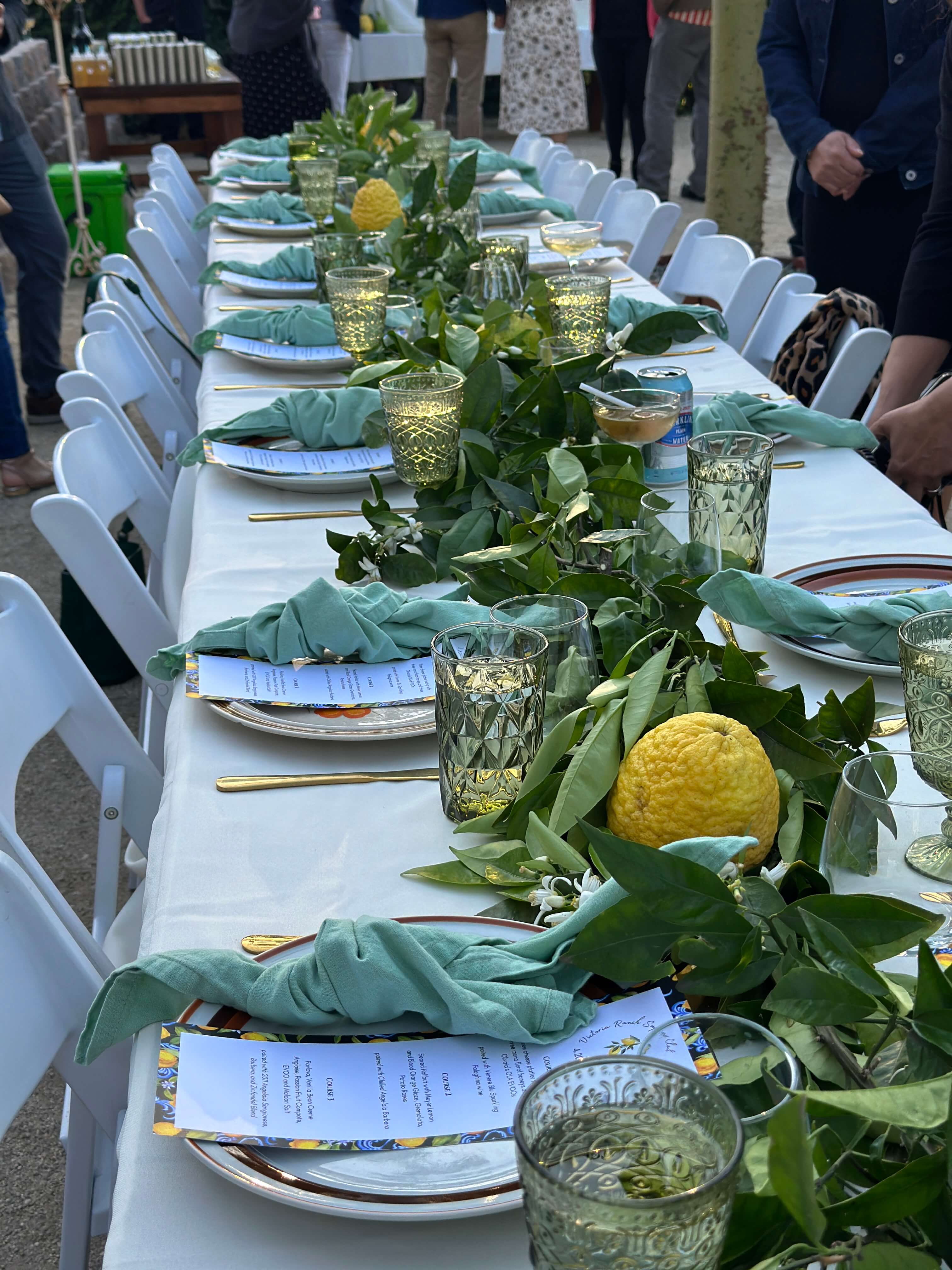Amalfi Coast-inspired plates adorned with lemon leaves and fresh citrus at Chef Joann Catering’s Victoria Ranch supper club, featuring Olivaia’s Ola olive oil-infused courses.