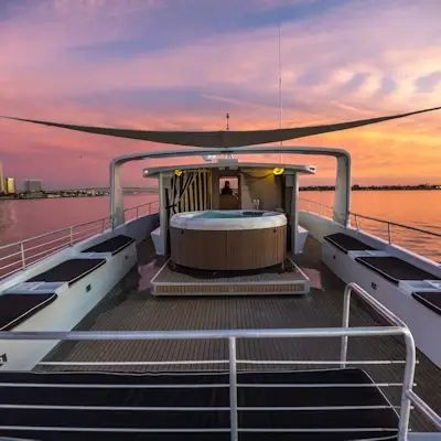 Luxury yacht event with waterfront dining on Zolna Yachts in San Diego, featuring ocean views, ambient lighting, and gourmet catering by Chef Joann for an upscale coastal experience.