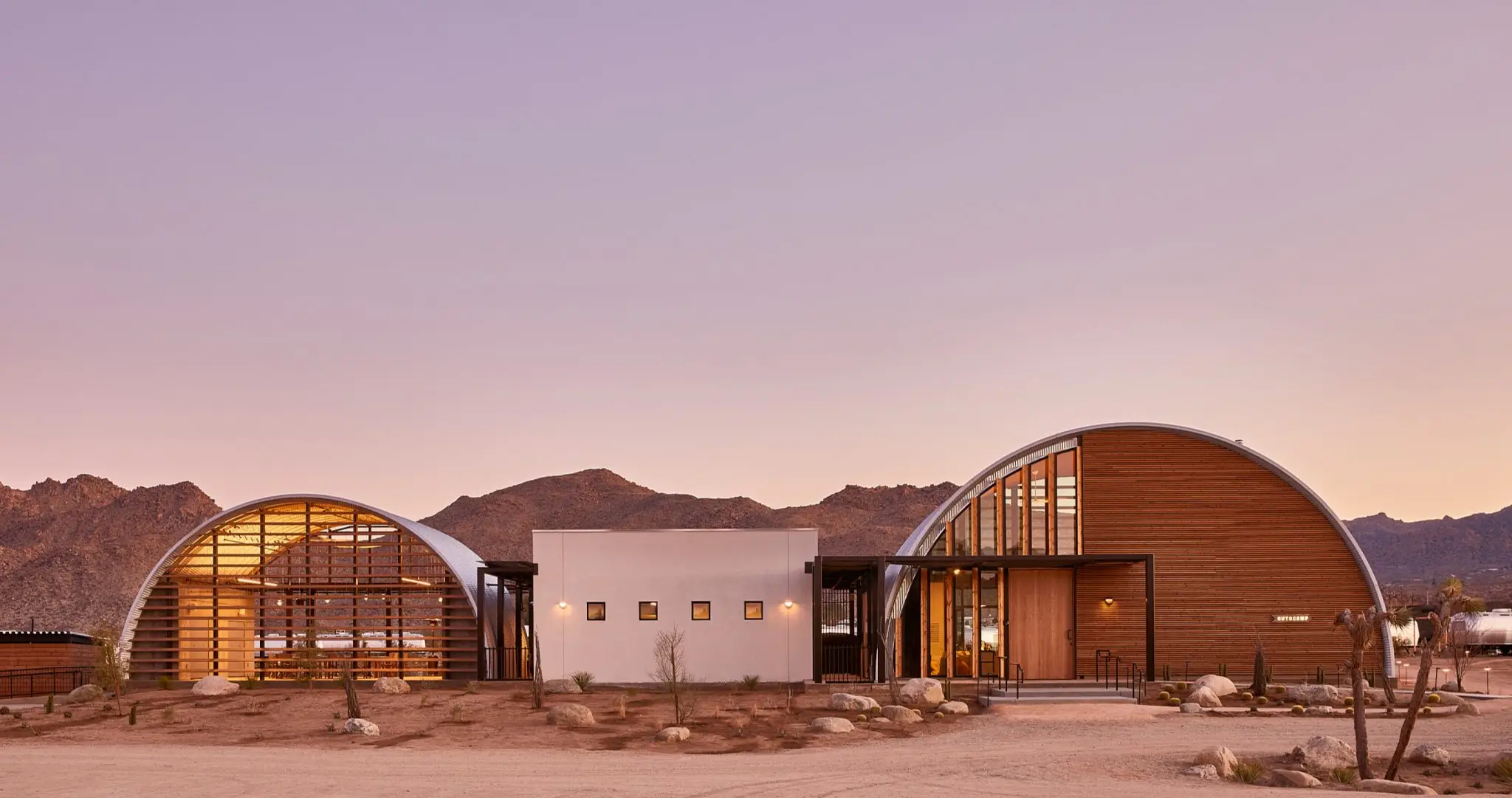Stylish Airstream interior at AutoCamp Joshua Tree with minimalist desert-chic décor, queen bed, and panoramic windows framing the California high desert – Chef Joann Catering’s intimate in-suite dining setting.