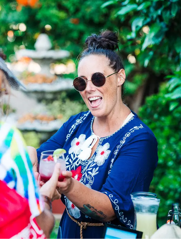 Smiling guest with champagne flute at Chef Joann Catering’s oceanfront La Jolla wedding