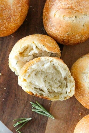 Rosemary Sourdough Rolls on wooden tray.