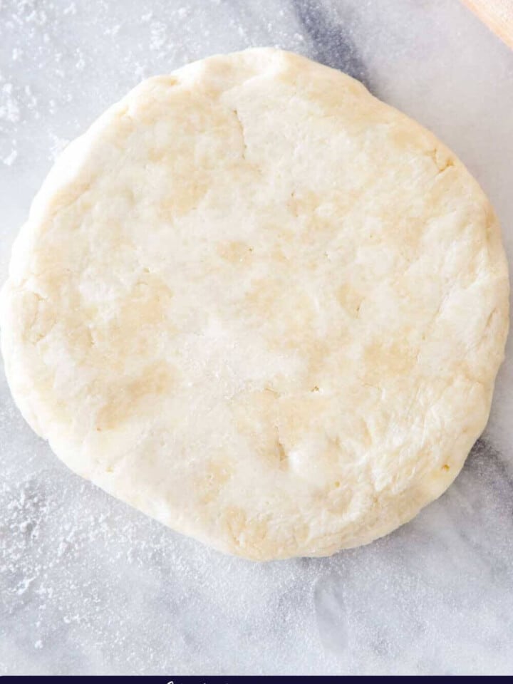 pie dough disk on marble.