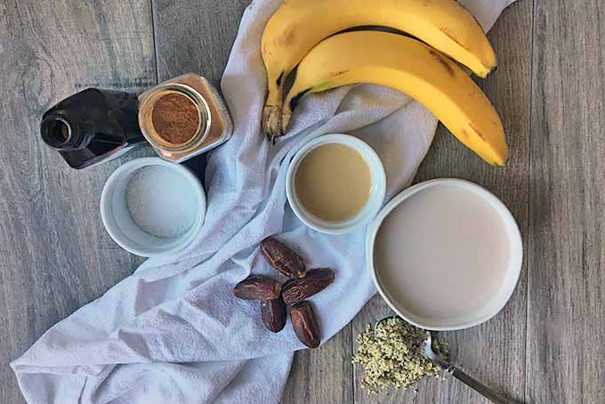 Horizontal image of ingredients for a tahini banana smoothie.