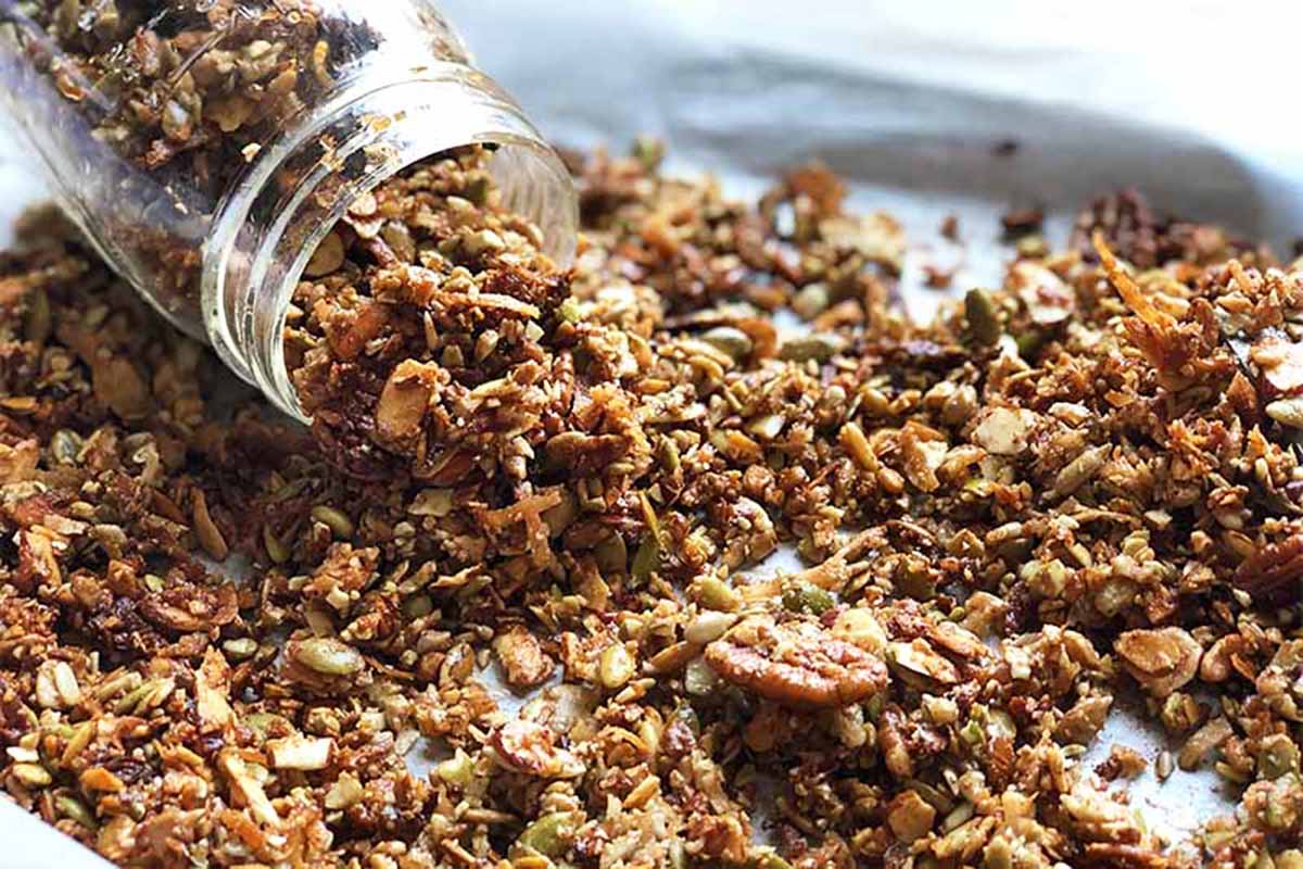 Horizontal image of a jar of oatmeal poured onto a baking sheet.