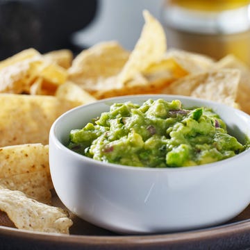 plate of corn tortilla chips with guacamole dip plate of corn tortilla chips with guacamole dip