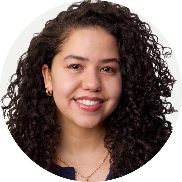 Portrait of a person with curly hair wearing earrings and a necklace. Portrait of a person with curly hair wearing earrings and a necklace.