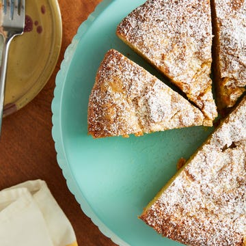 Slices of cake on a turquoise platter with a plate of cake and a fork nearby. Slices of cake on a turquoise platter with a plate of cake and a fork nearby.