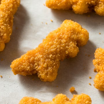 High angle view of fried chicken fingers in shape of dinosaur High angle view of fried chicken fingers in shape of dinosaur