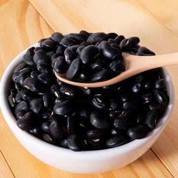 Black Beans in wooden spoon with ceramic bowl. Black Beans in wooden spoon with ceramic bowl.