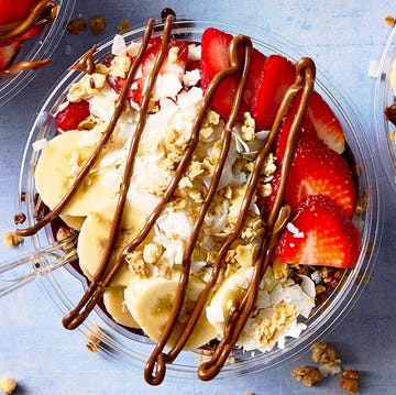 Acai Playa Bowl acai playa bowl topped with bananas, strawberries, coconut shreds, and granola