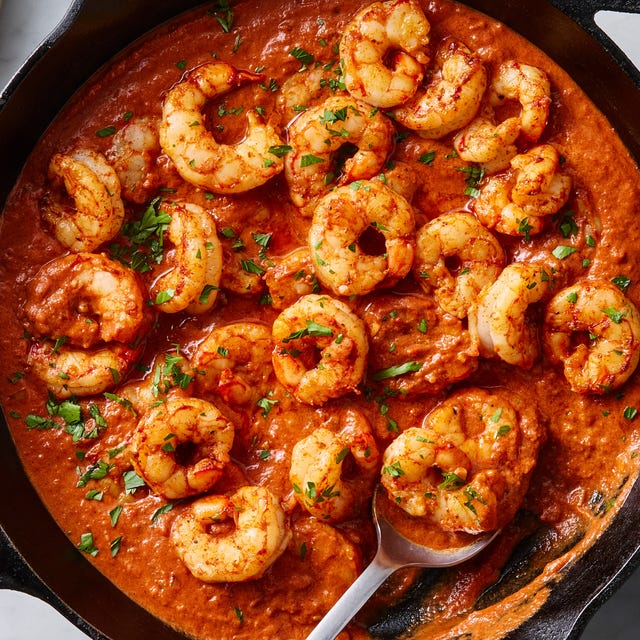 Shrimp cooked in a rich sauce with rice and chopped herbs. Shrimp cooked in a rich sauce with rice and chopped herbs.