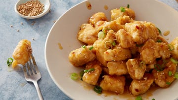 air fryer orange chicken with sesame seeds and green onions