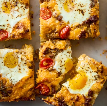 Breakfast Focaccia classic focaccia reimagined into the ultimate breakfast with crispy edges, layers of crumbled breakfast sausage, shredded cheese, and juicy cherry tomato and jammy eggs.