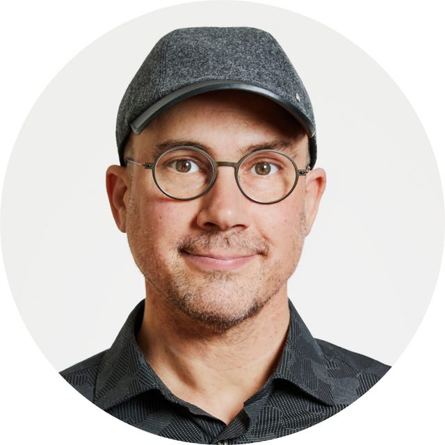 Person wearing a dark cap and patterned shirt.