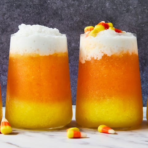 Candy Corn Coladas layered cocktail with yellow, orange, and white layers topped with candy corn