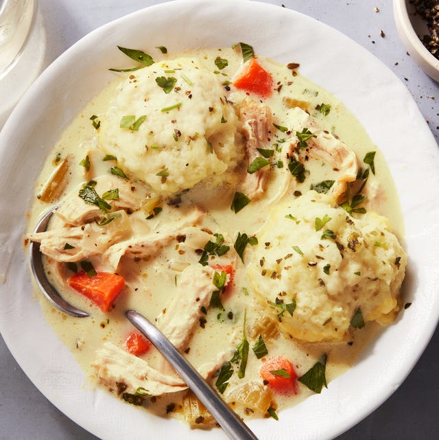 Chicken & Dumplings shredded chicken and dumplings and carrots in a creamy broth, topped with chopped parsley