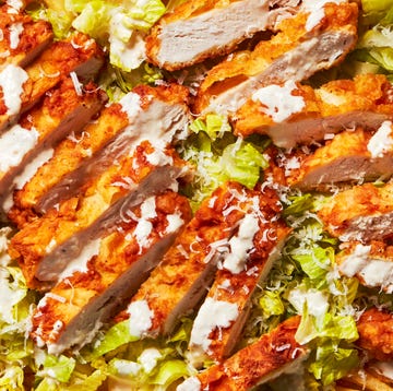 Chicken Caesar Fries caesar salad topped with fried chicken pieces over fries