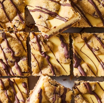 Cookie Dough Cheesecake Bars cheesecake bars with a cookie bottom and top layer drizzled with chocolate