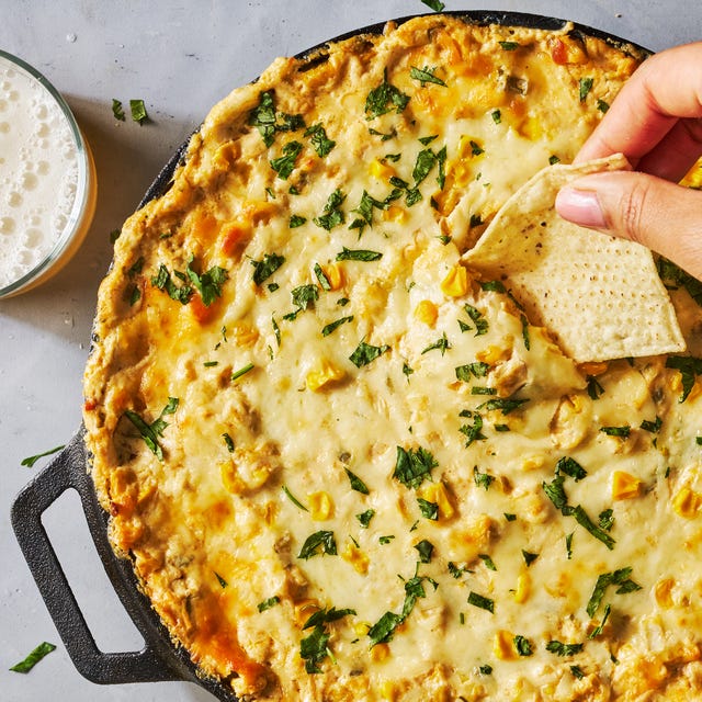 Corn Dip hot creamy corn dip in a cast iron skillet with tortilla chips