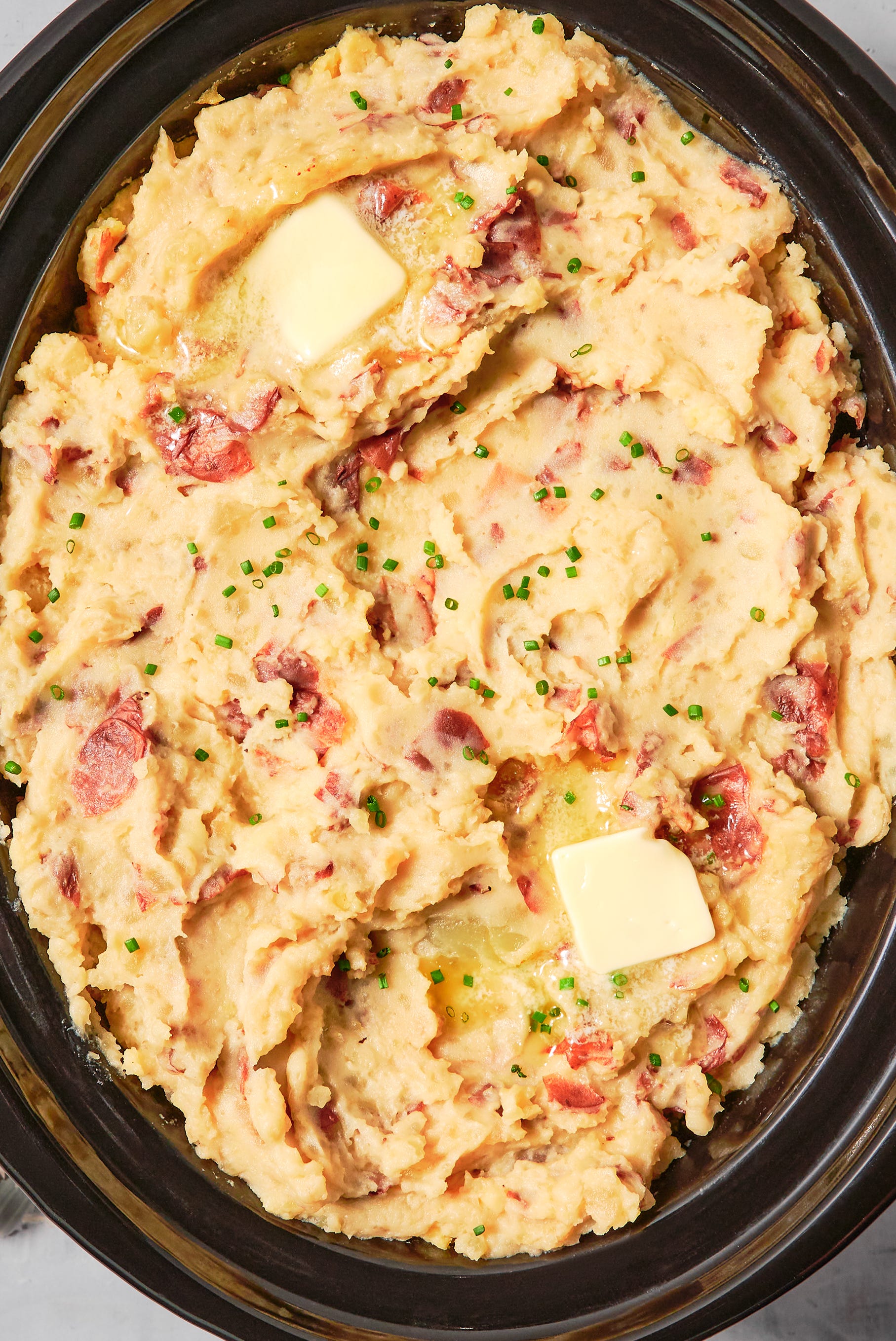 Crockpot Garlicky Mashed Potatoes mashed potatoes in a crockpot with garlic and butter