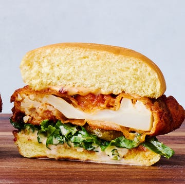 Dave's Hot Chicken Cauliflower Sliders hot cauliflower on a bun with sauce, slaw, and pickles