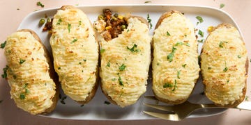 a saucy red wine spiked ground beef and vegetable mixture gets loaded into hollowed out russet potatoes, topped with parmesan mashed potatoes, and baked until golden brown
