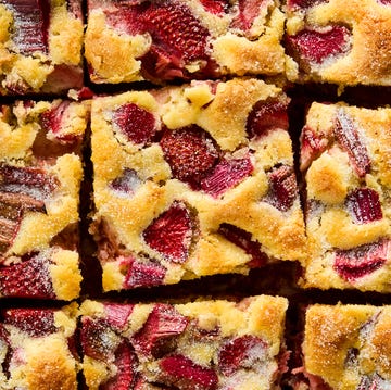 Strawberry Rhubarb Breakfast Cake a tray of square slices of cake with strawberry and rhubarb pieces distributed throughout