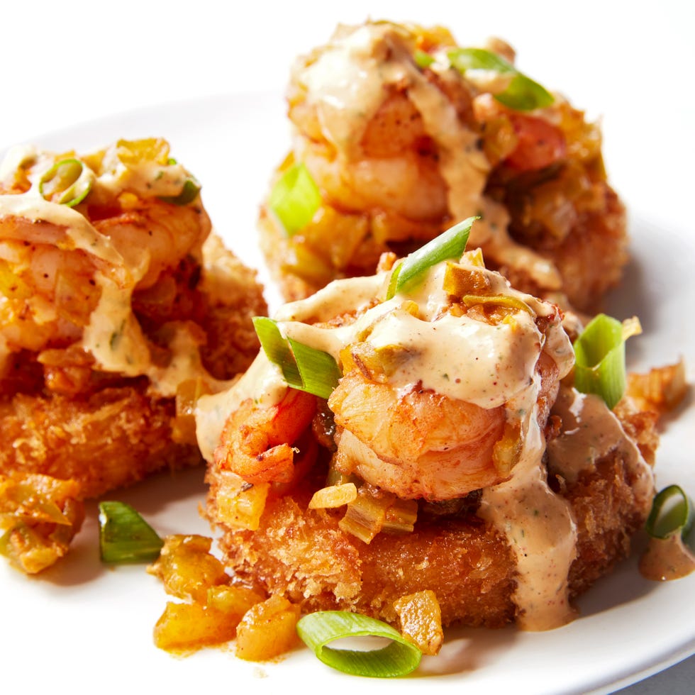 Cheesy Shrimp & Grit Bites smoked gouda grits, breaded and fried until crispy then topped with cajun seasoned shrimp and creamy remoulade sauce