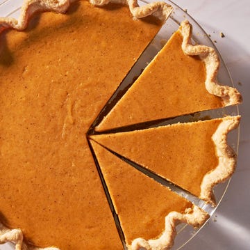 Sweet potato pie sweet potato pie on a white surface next to a pie server