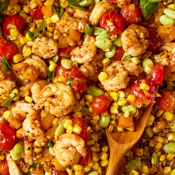Shrimp & Tomato Succotash Skillet blistered tomatoes and charred corn tossed with onion, bell pepper, lima beans, and seared cajun spiced shrimp then topped with torn basil