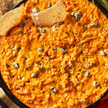 Buffalo chicken dip buffalo chicken dip in a skillet beside carrots, celery, and tortilla chips