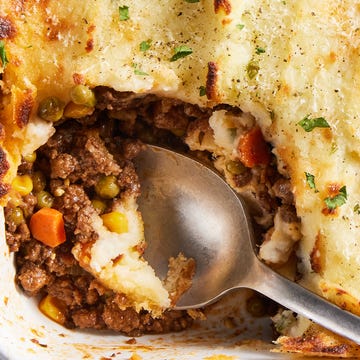 Shepherd's Pie ground beef cooked with aromatics and red wine, then combined with corn and peas and covered with a blanket of velvety, rich mashed potatoes, then topped with parmesan and broiled until golden brown
