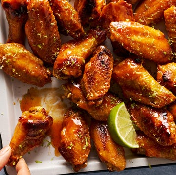 Coconut lime chicken wings coconut lime chicken wings on a tray with lime wedges