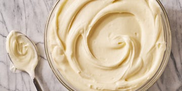 cream cheese frosting in a bowl with a spoon