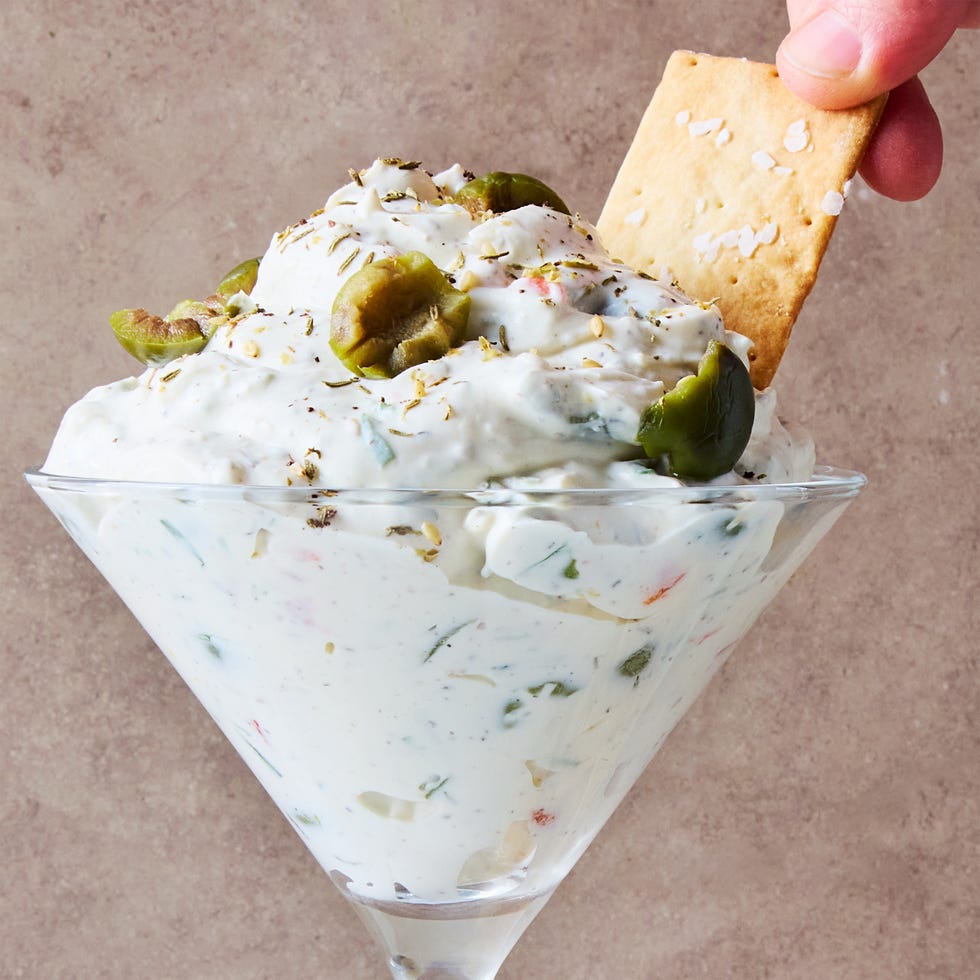 fluffy whipped cream cheese, crumbled feta, citrus topped with chopped green olives, pimento peppers, and a little bit of booze