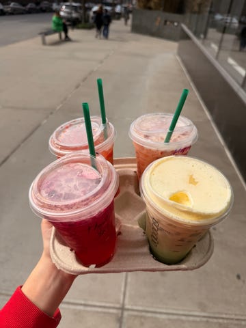 Tray holding four different drinks on a sidewalk. Tray holding four different drinks on a sidewalk.