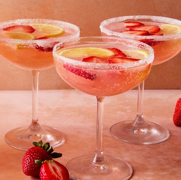 Giggle Juice pink cocktail with sliced strawberries and lemon