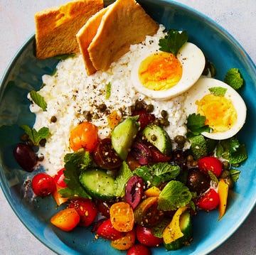 Greek Salad Cottage Cheese Bowl cottage cheese, soft boiled eggs, and a cucumber tomato salad topped with pita chips
