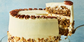 Hummingbird Cake layered cake with frosting topped with pecans