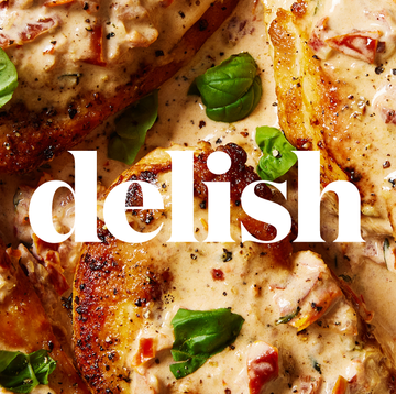 cooked chicken with delish logo on top cooked chicken with delish logo on top