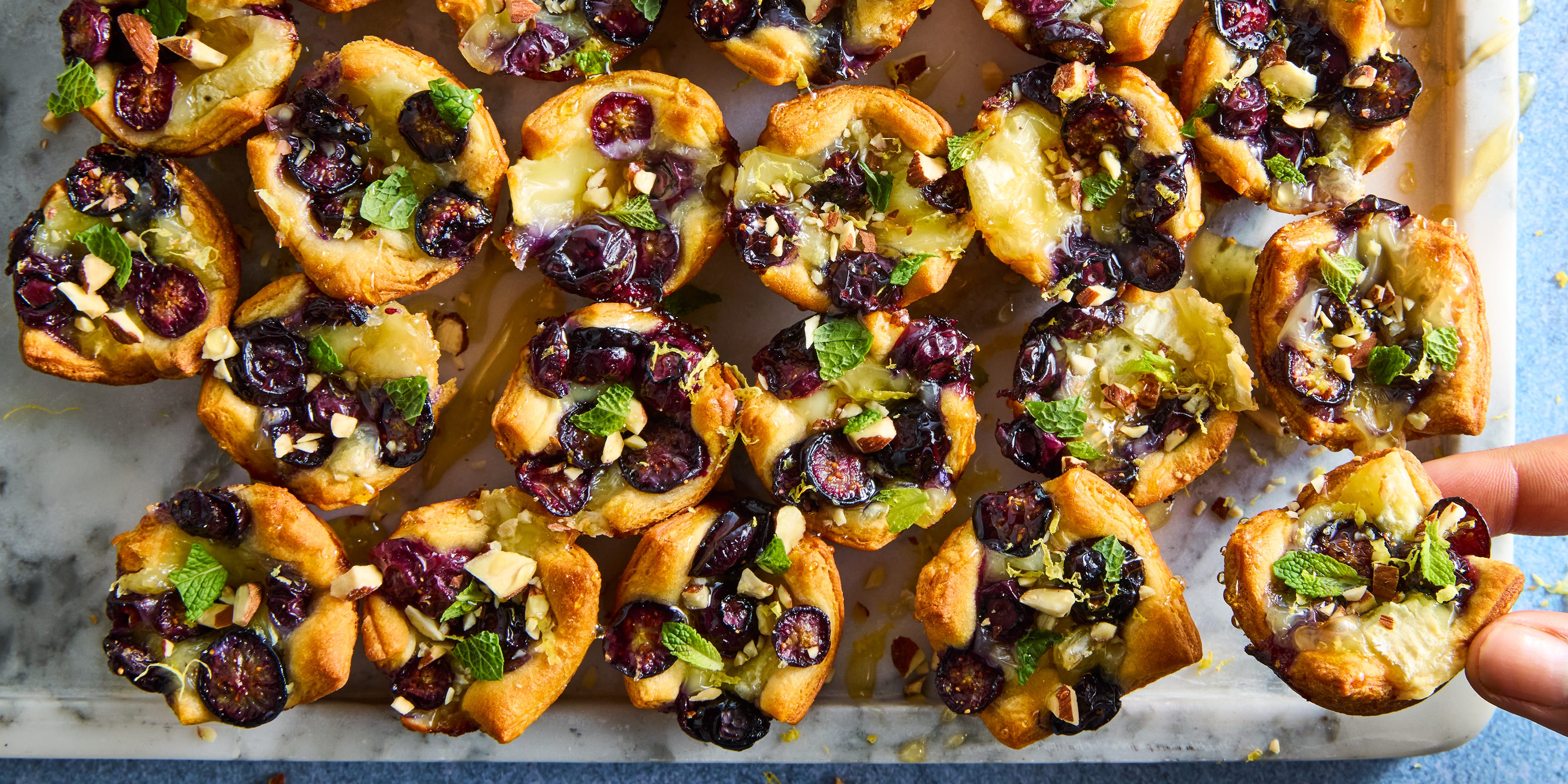 Lemon Blueberry Brie Bites crescent dough baked and filled with brie, sliced blueberries, almonds, and honey