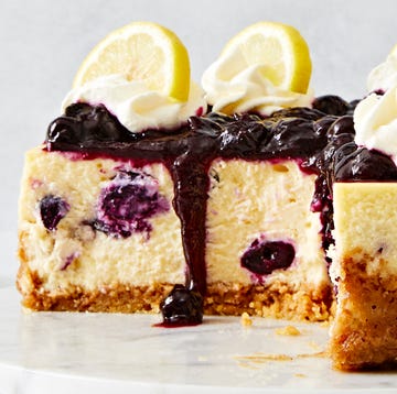 Lemon-Blueberry Cheesecake lemon blueberry cheesecake topped with a jammy blueberry topping, whipped cream and lemon slices