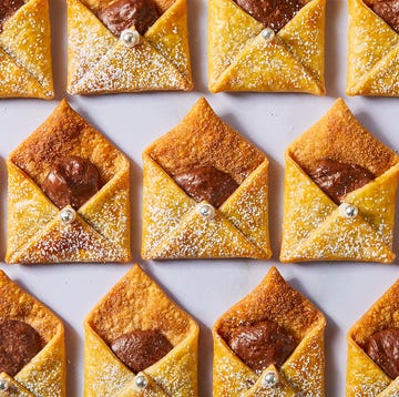 Letters To Santa letter shaped pastries filled with chocolate and cinnamon sugar on a plate with milk
