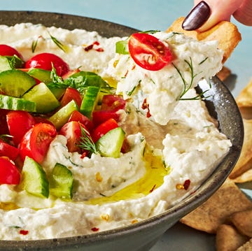 Loaded Greek Feta Dip feta dip in a bowl topped with tomatoes and cucumber