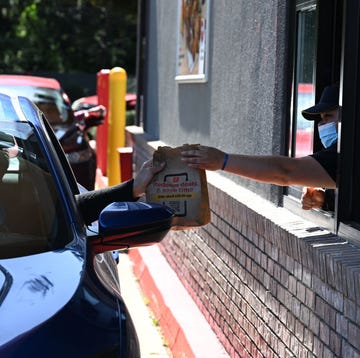 mcdonalds employee handing bag to car in drive thru mcdonalds employee handing bag to car in drive thru