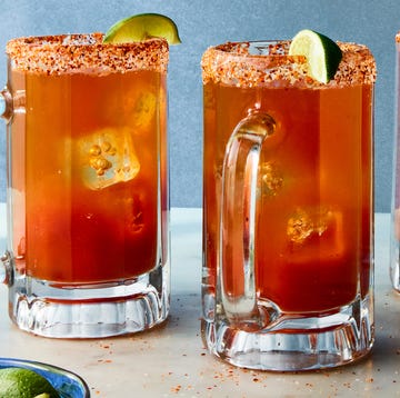 Michelada michelada in a glass with a tajin rim and lime garnish