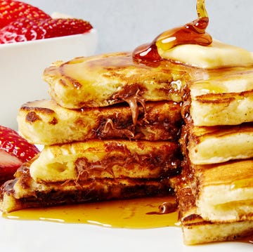 Nutella Stuffed Pancakes three pancakes stuffed with nutella and topped with butter and syrup