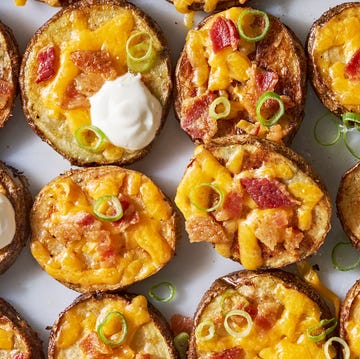 Potato Skin Bites circles of crispy potatoes with melted cheese, bacon and dollops of sour cream