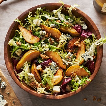 Roasted Pear Salad roasted pear salad with mixed greens, candied pepitas, and blue cheese in a wooden bowl