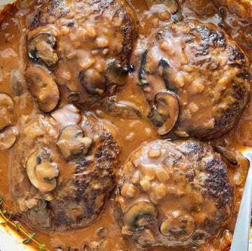 Salisbury steak ground beef patties in a pan with mushroom gravy